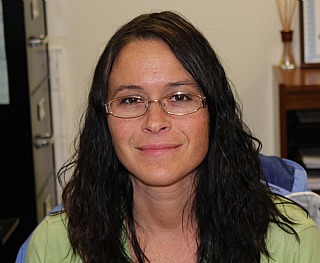 Portrait of a woman smiling in an office.
