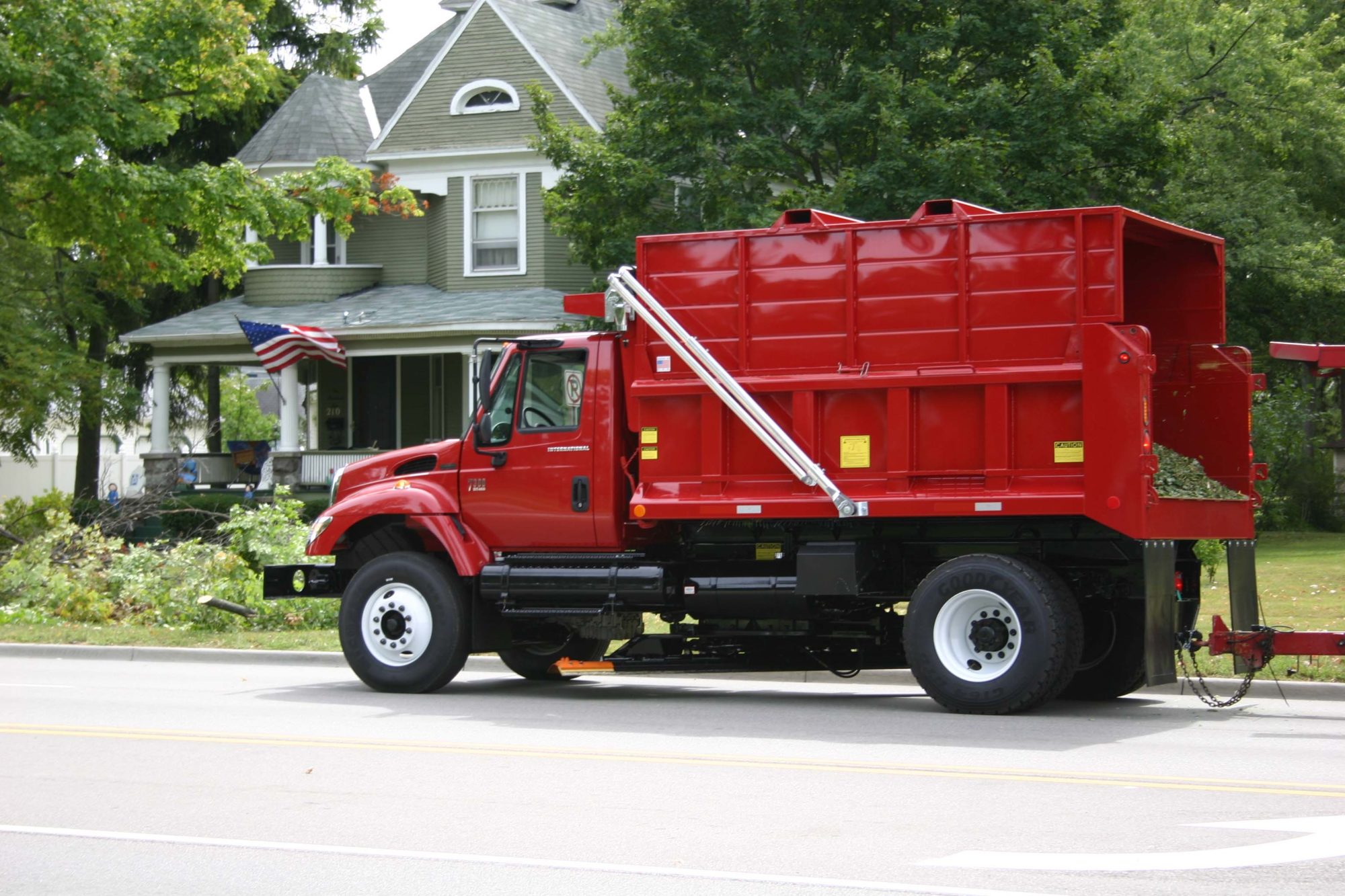 Dump Truck Receiving Waste from House