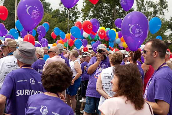 People Gathering with Purple Balloons