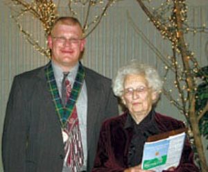 A photograph of Jean Nevins and the winner of the Tartan Award for the year.