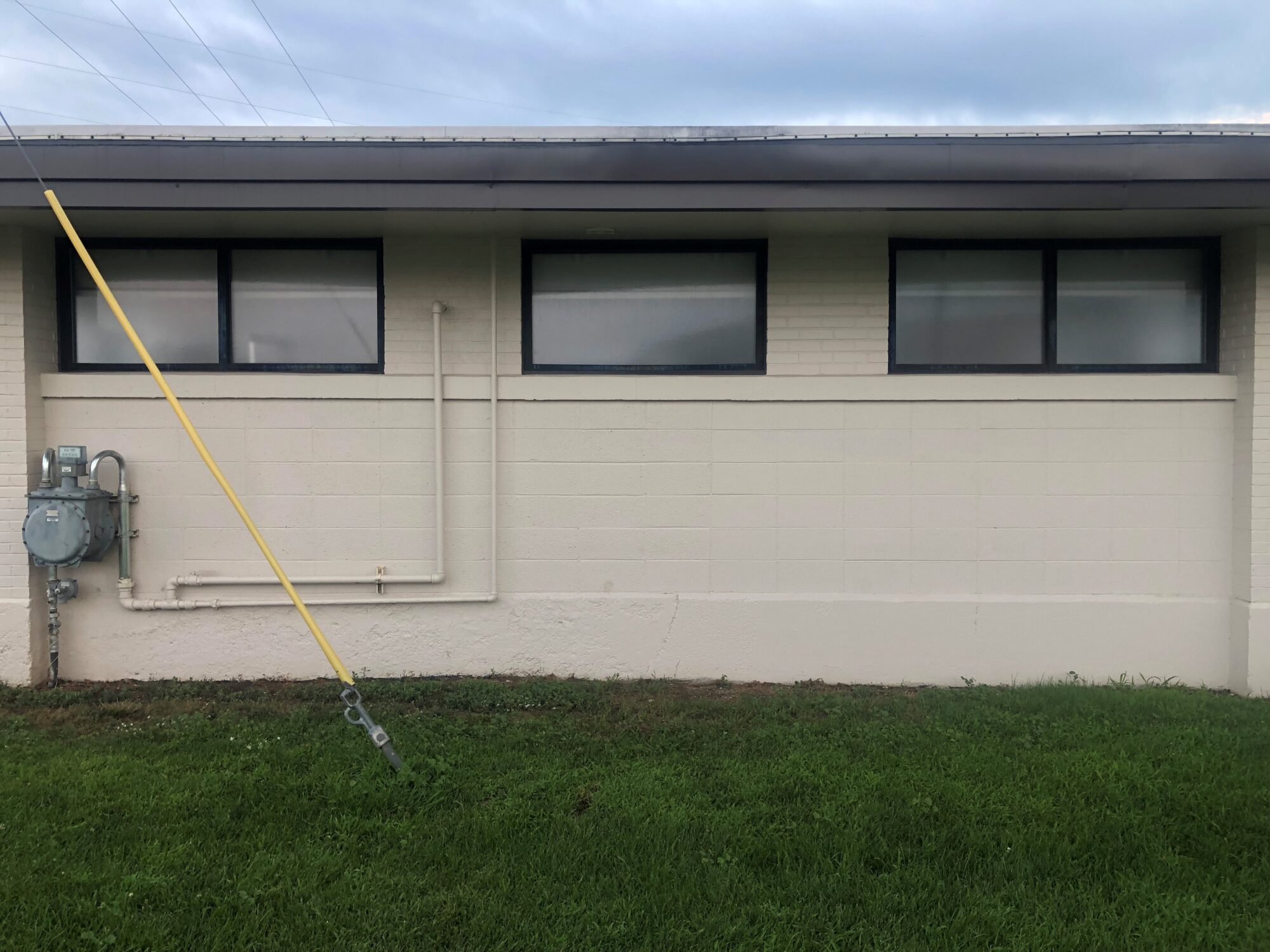 An image of the cleaned south facing wall of the W.T. Morris Swimming Pool House.