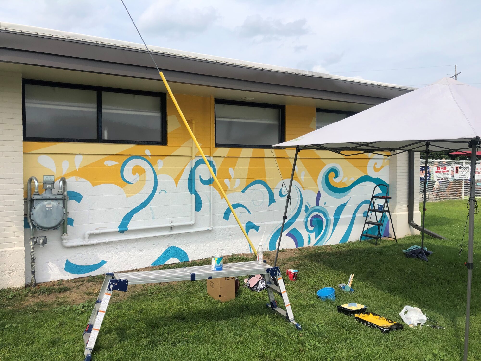 The state of the mural at end of day on August 9th. The sun appears to be done, while the waves are beginning to take shape.