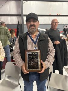 Alex Velazco holding Spirit of St. Louis award plaque.