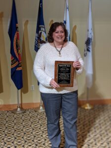 Melissa Allen holding her Spirit of St. Louis award plaque